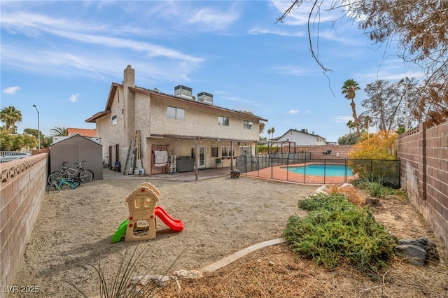 exterior space featuring a fenced in pool and a patio