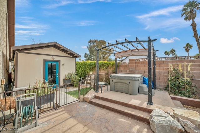 view of patio / terrace featuring an outdoor structure, a pergola, and a hot tub