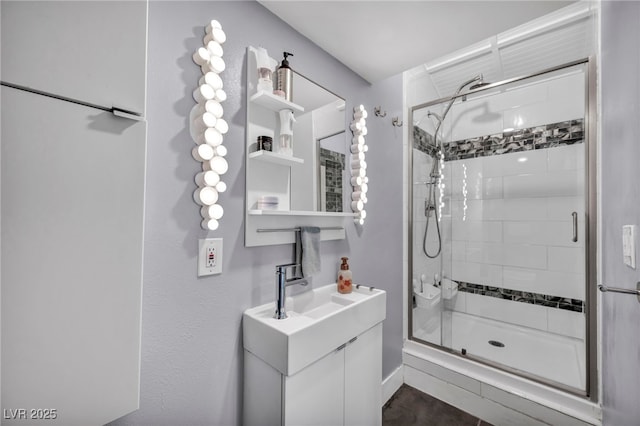 bathroom featuring vanity and a shower with shower door