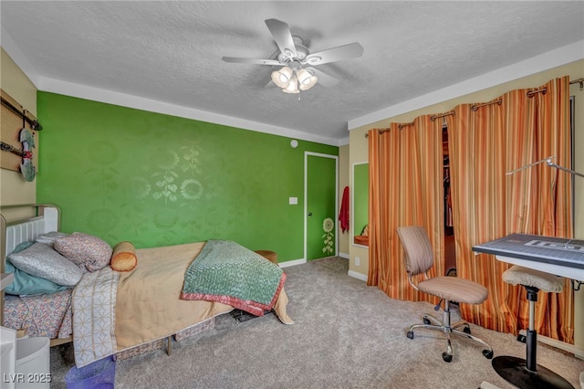 carpeted bedroom featuring ceiling fan and a textured ceiling