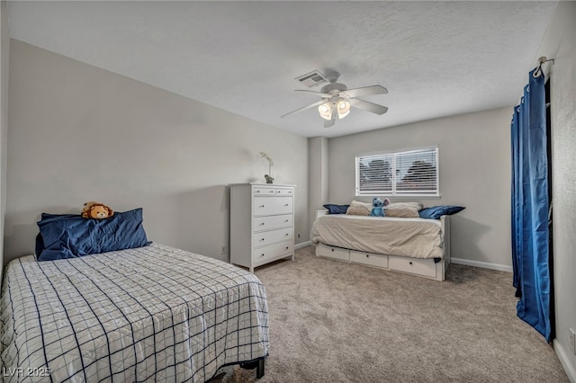 bedroom featuring light carpet, a textured ceiling, and ceiling fan