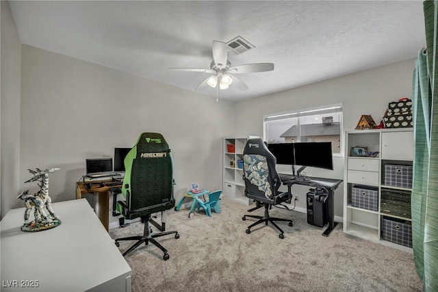 carpeted office with ceiling fan and a textured ceiling