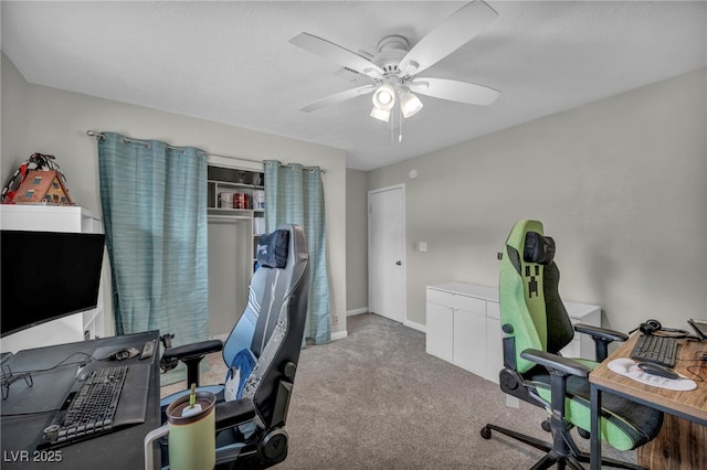 office area with ceiling fan and light carpet