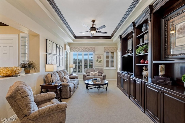 sunroom / solarium with ceiling fan and a tray ceiling