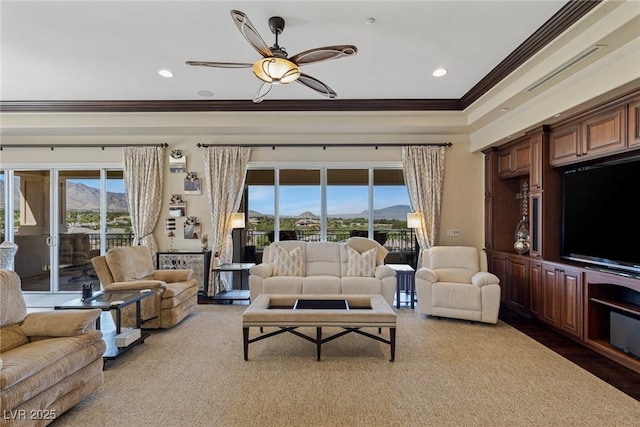 living room with crown molding, ceiling fan, and a mountain view