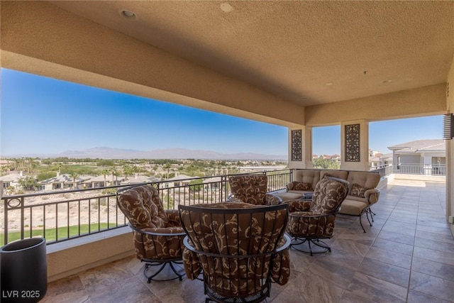 view of patio with a balcony and a mountain view