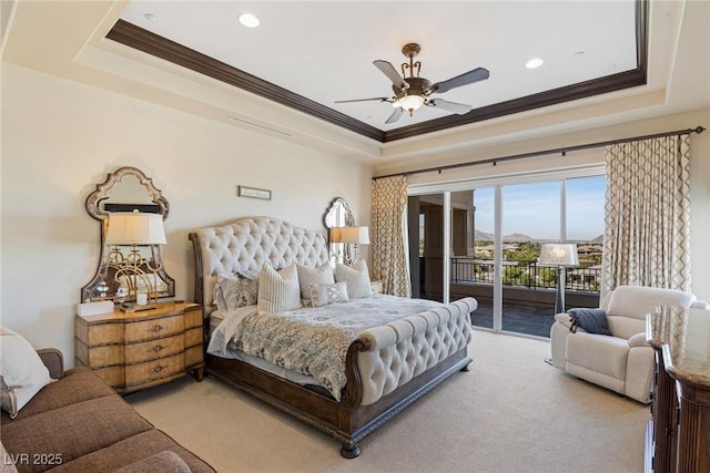 bedroom with ornamental molding, access to outside, light colored carpet, and a raised ceiling