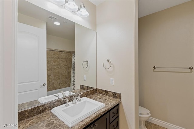 bathroom with vanity, curtained shower, and toilet