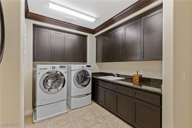 laundry area with cabinets, crown molding, sink, and washer and clothes dryer