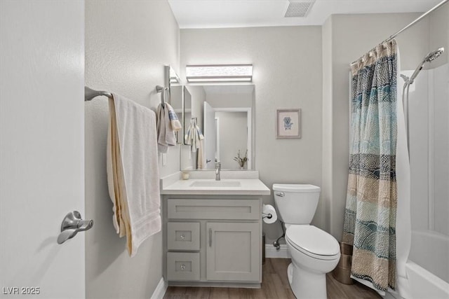 full bathroom with vanity, hardwood / wood-style floors, shower / tub combo with curtain, and toilet