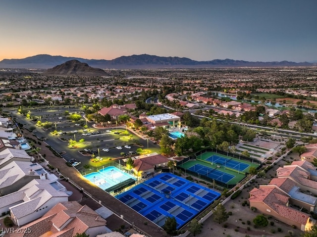 aerial view at dusk featuring a mountain view