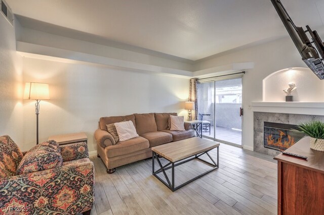 living room with a fireplace and light hardwood / wood-style floors