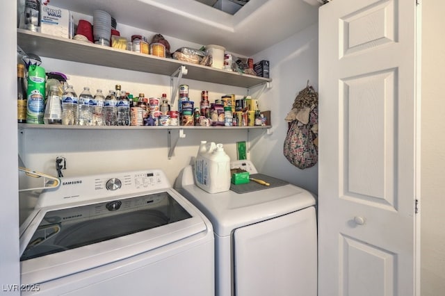 clothes washing area featuring laundry area and washer and clothes dryer