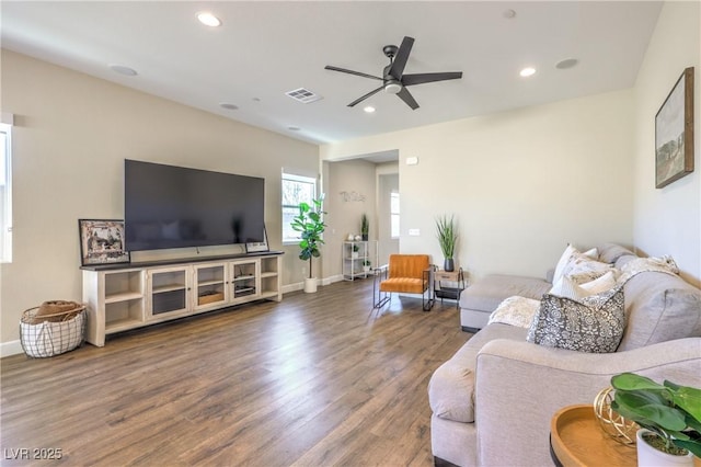 living room featuring hardwood / wood-style floors and ceiling fan