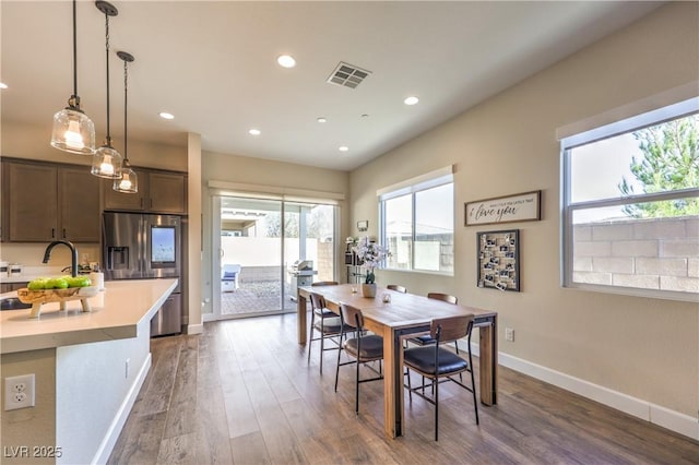 dining space featuring dark wood-type flooring