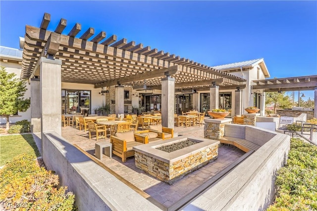 view of patio with a pergola and a fire pit