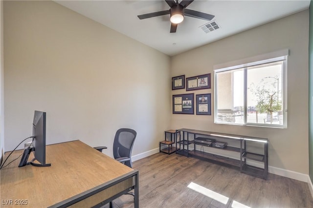 office with hardwood / wood-style flooring and ceiling fan