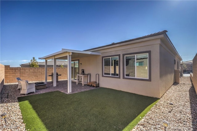 rear view of house with a yard and a patio area