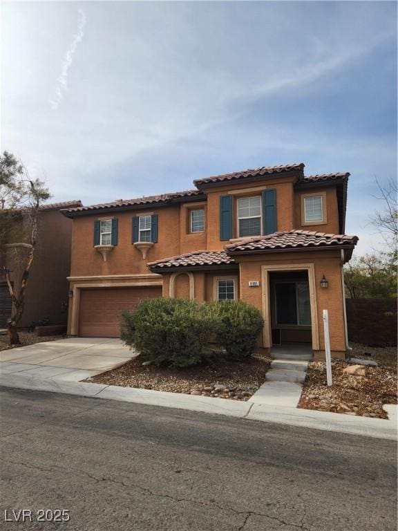 mediterranean / spanish-style home featuring a garage