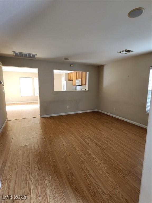 empty room with light hardwood / wood-style floors