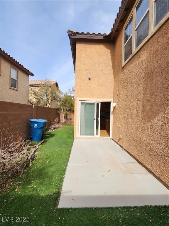 rear view of property with a yard and a patio area