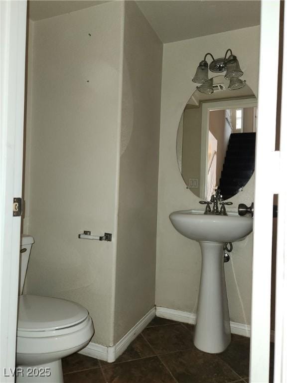 bathroom featuring tile patterned floors and toilet