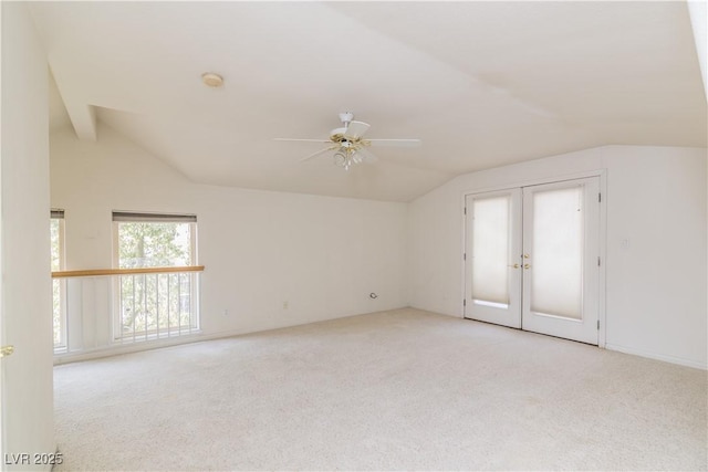 carpeted spare room with lofted ceiling and ceiling fan