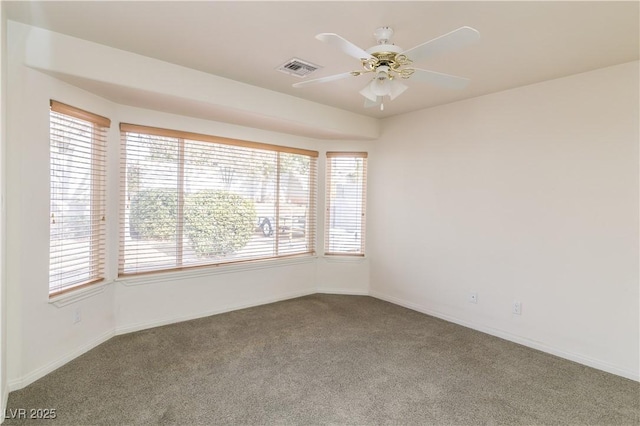 empty room with ceiling fan and carpet floors