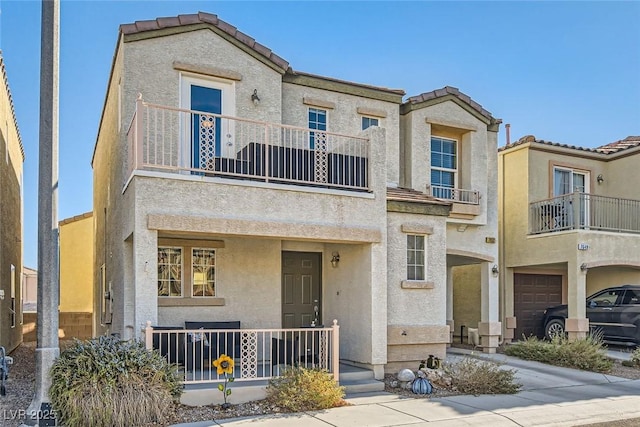 view of property with a garage and a balcony