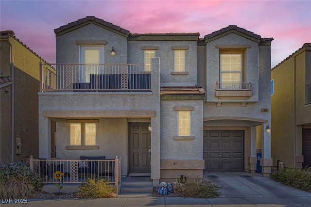 view of front of house featuring a garage and a balcony