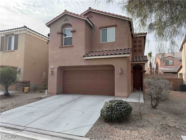 mediterranean / spanish-style home with a garage