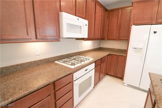 kitchen with white appliances and stone countertops