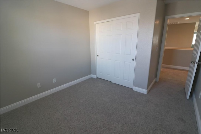 unfurnished bedroom featuring carpet floors and a closet