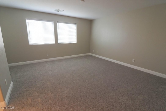 unfurnished room with dark carpet