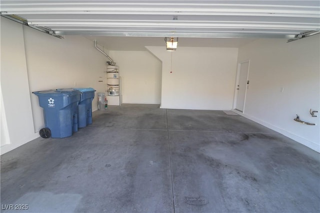 garage featuring a garage door opener and gas water heater