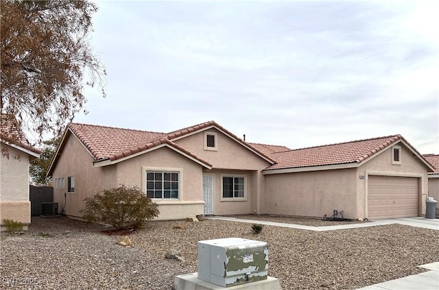 view of front facade with a garage and central AC unit