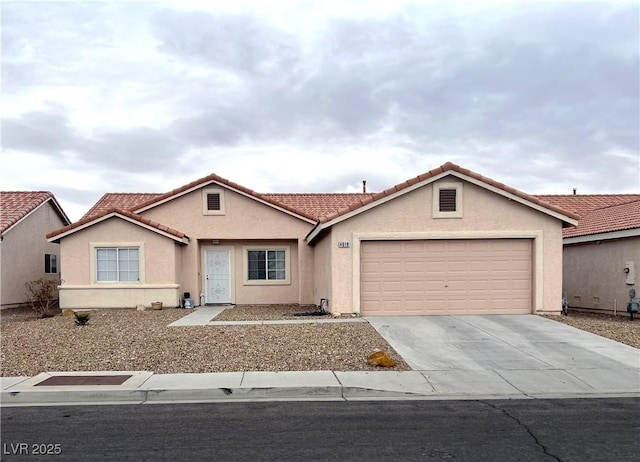 view of front of property featuring driveway, an attached garage, a tiled roof, and stucco siding