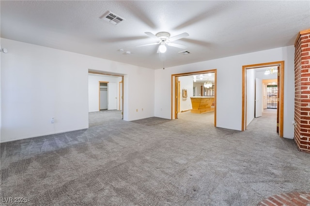 carpeted empty room featuring a textured ceiling and ceiling fan