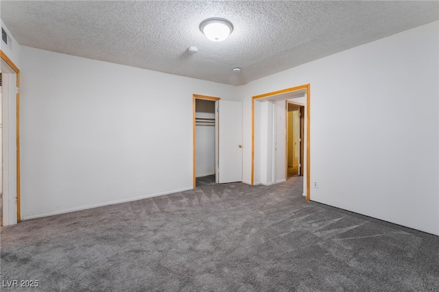 unfurnished bedroom featuring dark carpet, a closet, and a textured ceiling