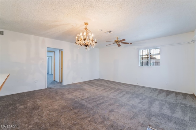 spare room featuring carpet, a notable chandelier, and a textured ceiling