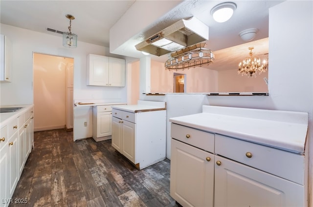 kitchen with white cabinetry, sink, pendant lighting, and dark hardwood / wood-style flooring