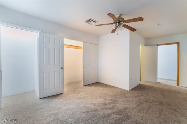 unfurnished bedroom featuring ceiling fan and light carpet