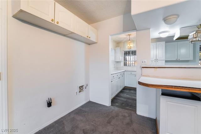 kitchen with pendant lighting, dark colored carpet, a textured ceiling, and white cabinets