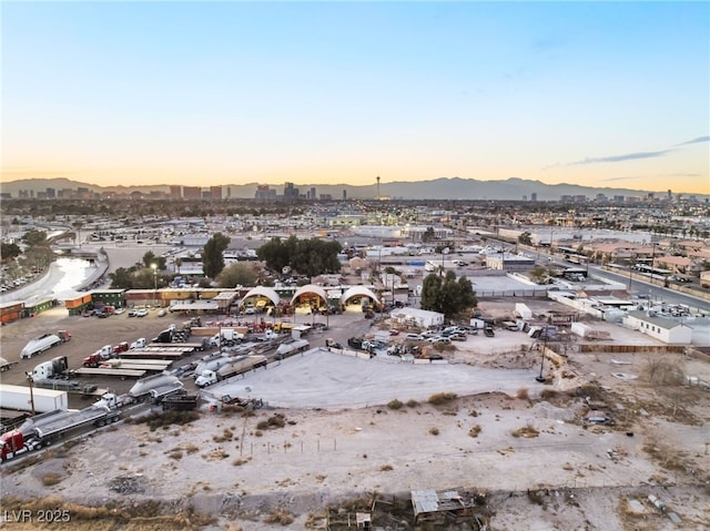 aerial view at dusk featuring a mountain view