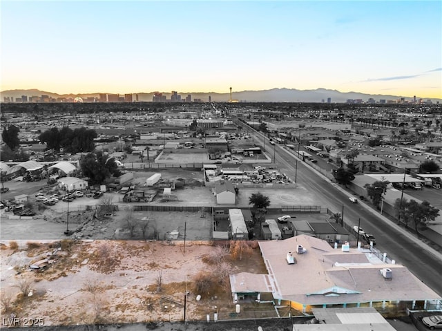 aerial view at dusk featuring a mountain view