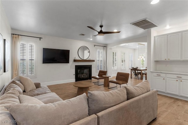 living room featuring ceiling fan and light wood-type flooring