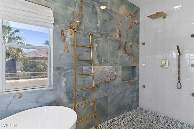 bathroom featuring plus walk in shower and plenty of natural light