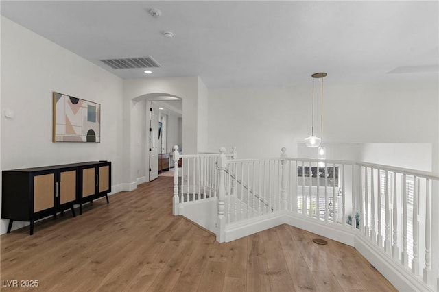 hallway with hardwood / wood-style floors