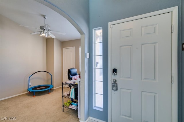 entryway featuring light colored carpet and ceiling fan