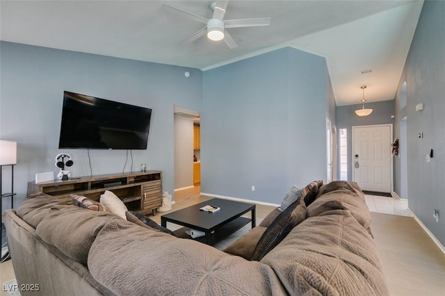 living room with vaulted ceiling, light wood-type flooring, and ceiling fan